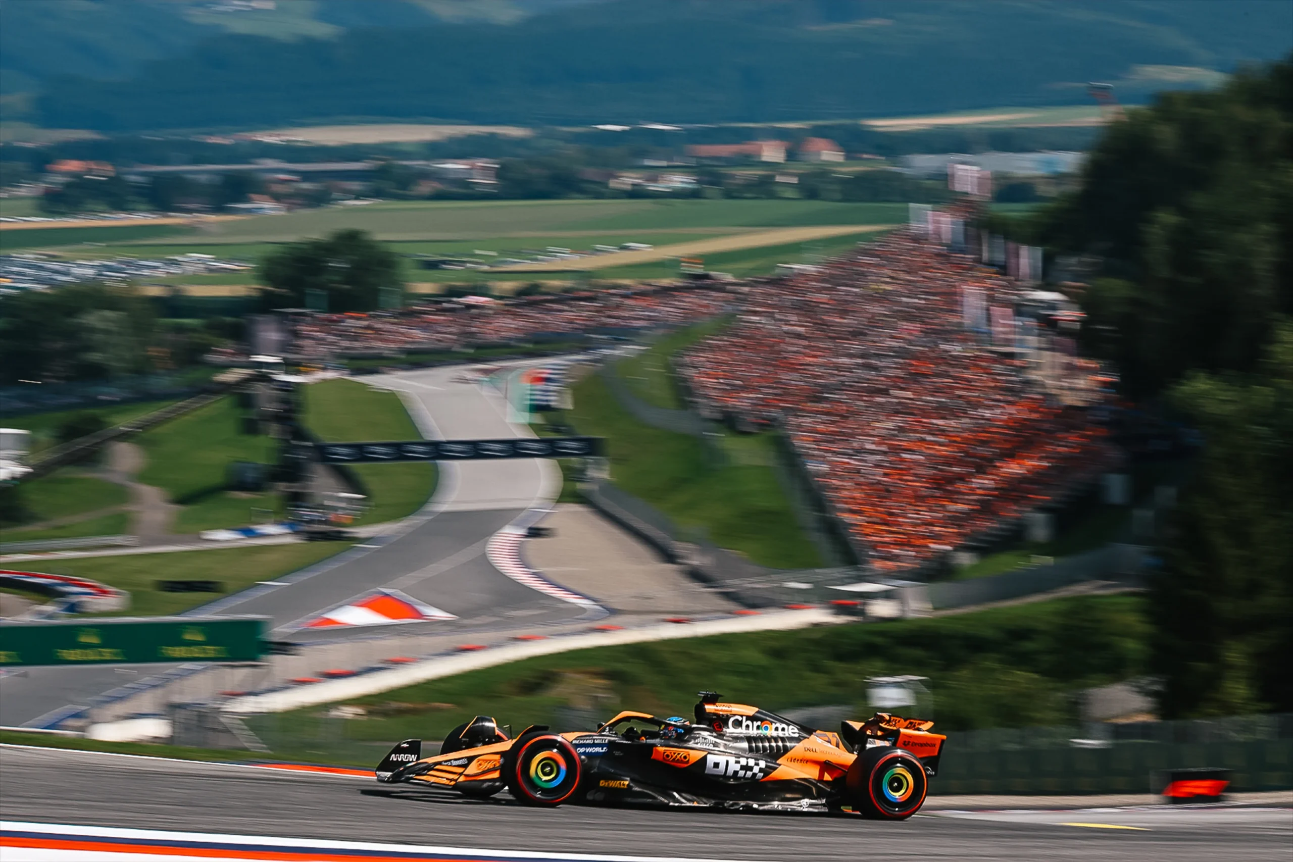 A 2026 Formula 1 car cresting the uphill braking zone at the Red Bull Ring during the Austrian Grand Prix