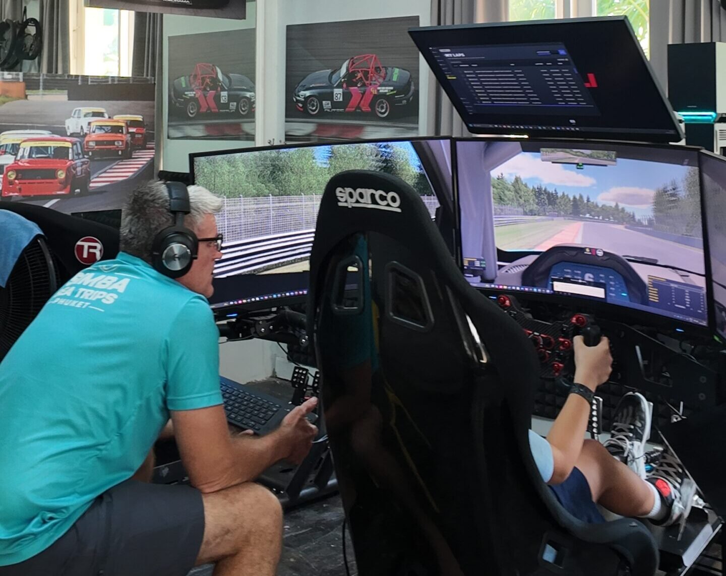 Coach reviewing braking telemetry from a virtual lap of Silverstone with a guest at SIMPRO Academy Phuket, Boat Lagoon Marina